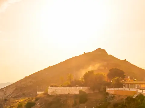 Morning sun over a hillside above the coast