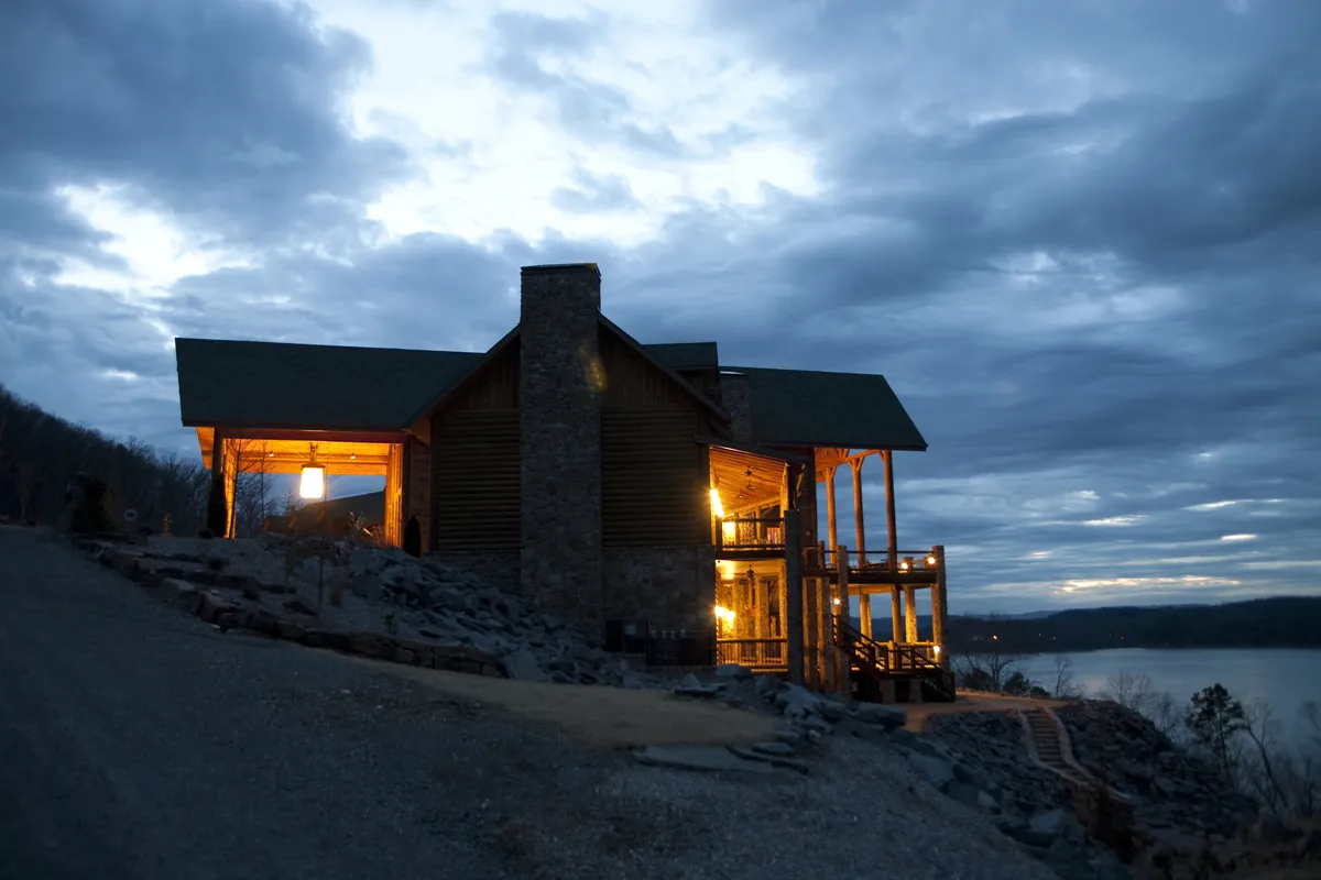 Lake house among pines in Canada at dusk
